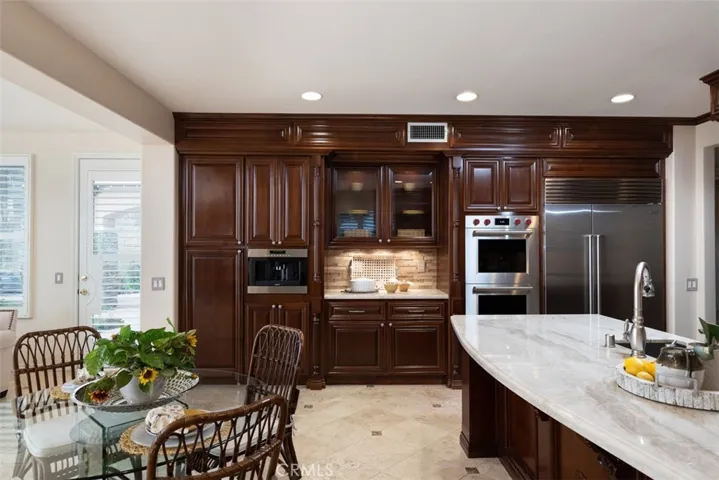 Notice the built-in WOLF coffee/espresso machine, under cabinet lighting, WOLF double ovens and warming drawer, SUB ZERO oversized refrigerator along with custom color optional floor lighting with remotes.