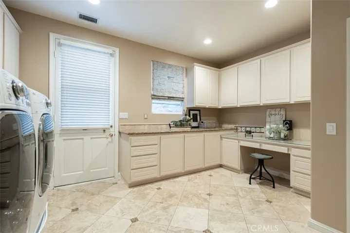 Incredible Laundry Room with Granite Counters, Custom Stainless Steel Sink and Huge Spaces!  Wonderful option for hobbies or an Artist Room!