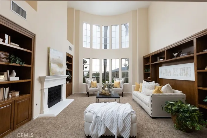 Formal living room with expansive 24 foot ceilings and stunning curved walls of glass to enjoy the views!
