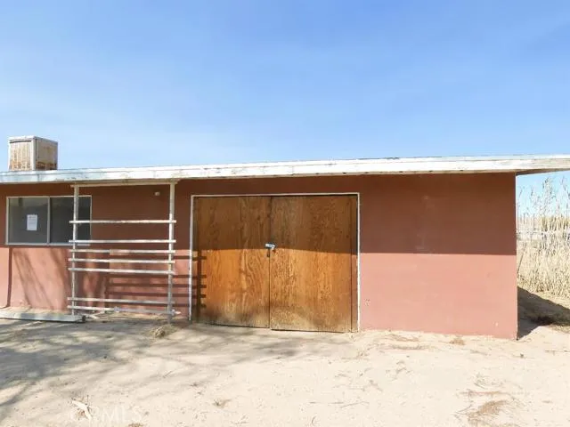 Front of work shop, could be turned into a double garage with modification & enlargement of the existing doors & door opening.