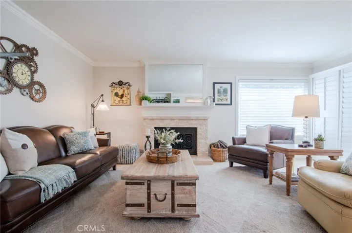 Family room with a stone faced fireplace with iron screen.