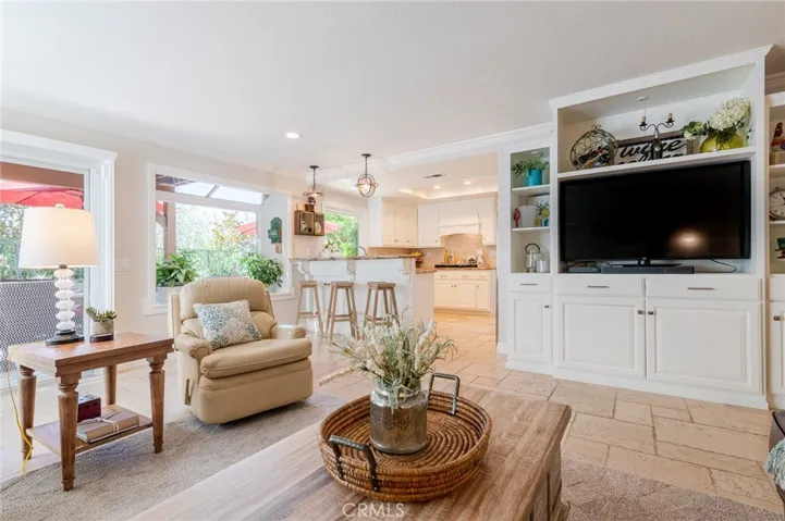 Family room with entertainment center and access to the backyard and pool.