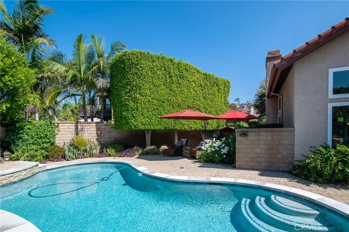 Private backyard with a pool and lush landscaping.