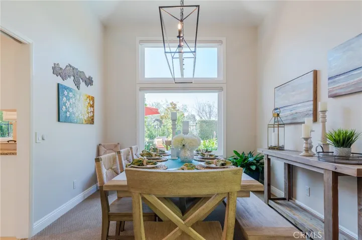 Formal dining room with a picture window and custom lighting.