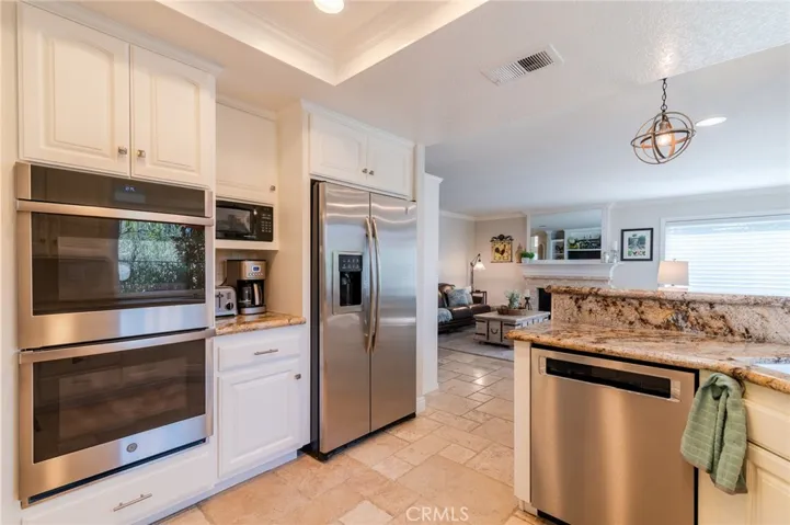 Kitchen with stainless steel appliances and recessed lighting.
