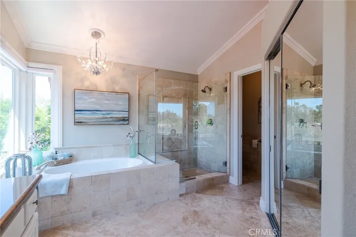 Master bathroom with travertine shower and tub.