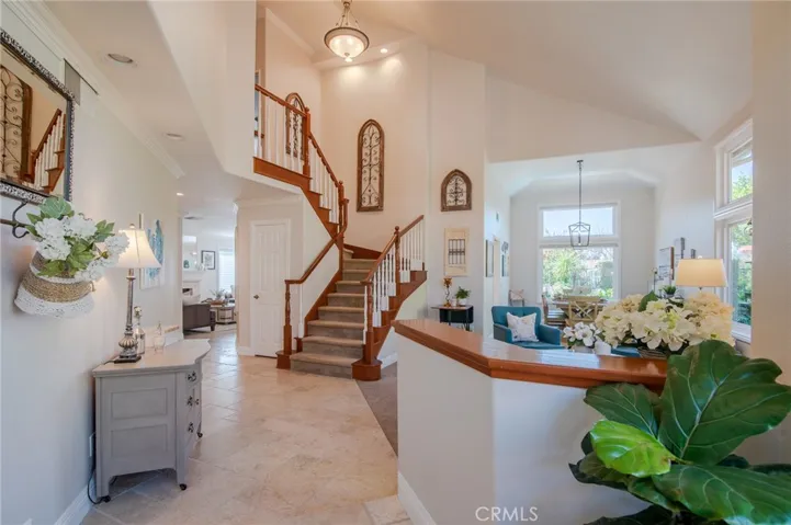 Front entry with tumbled travertine, vaulted ceilings / Living Room and Dining Room