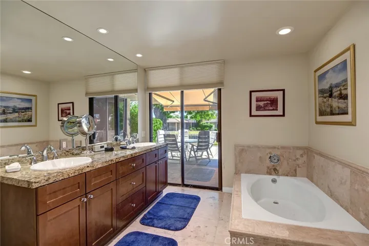 Primary bathroom with view to back patio