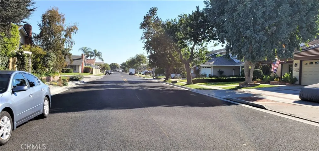 Subject property on the right with a flag