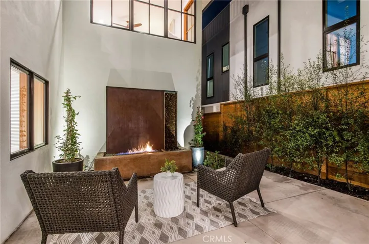 Relax by the fireplace outside in the courtyard.