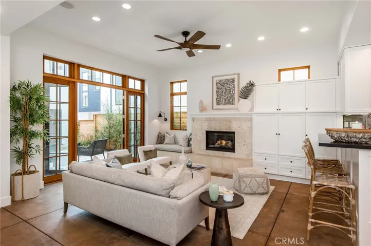 Living room with ultra high ceilings and expansive French doors to courtyard.
