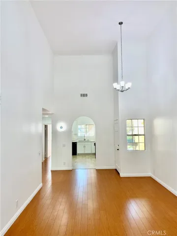 View of living room from patio. New paint. New recessed lights. High ceiling.