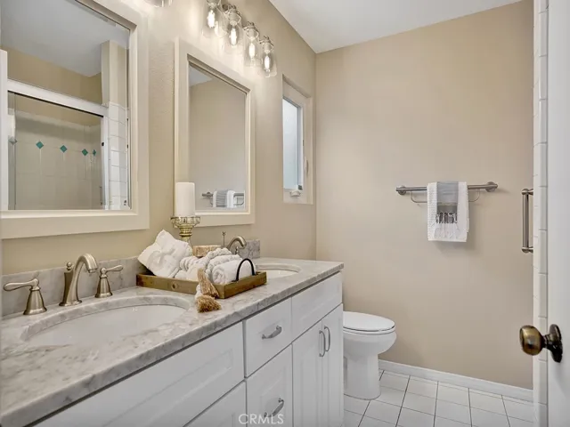 En-suite bathroom with marble countertops and dual sinks.