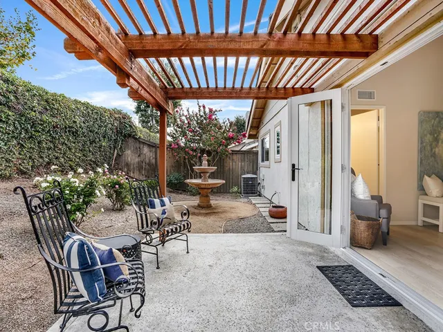 A bubbling garden fountain is a beautiful backdrop to the sitting area in the backyard garden.