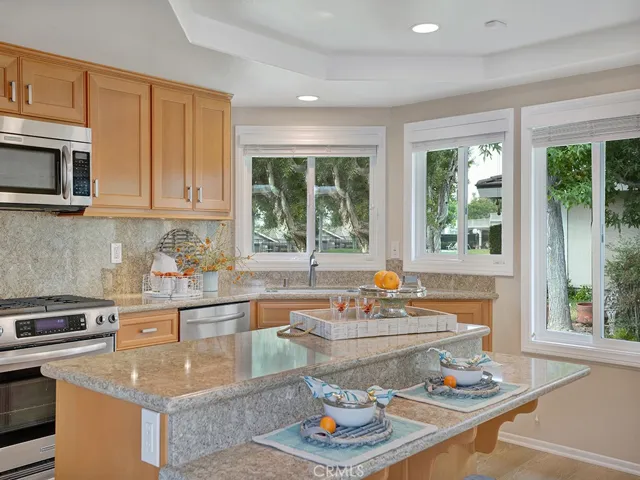 The warm and inviting kitchen features a kitchen island and windows providing tons of light.