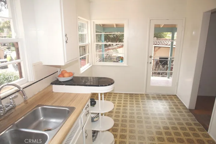 Original Kitchen with new faucet.  Stainless Steel sink has
garbage disposal.  Freshly painted but needs some love.
