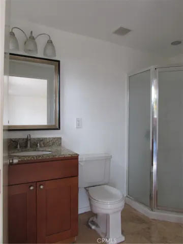 Master bath has tiled flooring, granite top on the vanity and a walk in shower