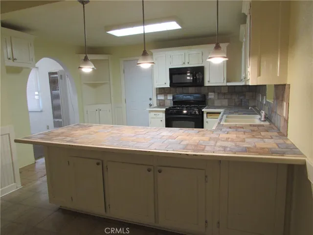 Nice pendant lighting over the breakfast counter, with storage underneath