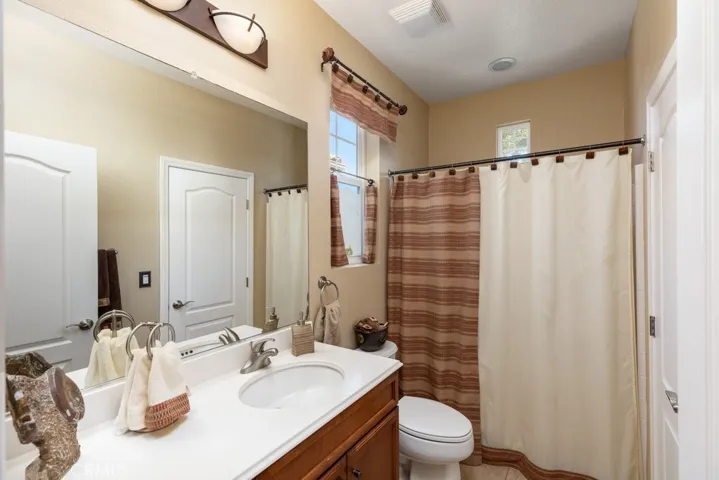 Guest bathroom - shower over tub - walk-through door on right to access guest bedroom in the front of the home