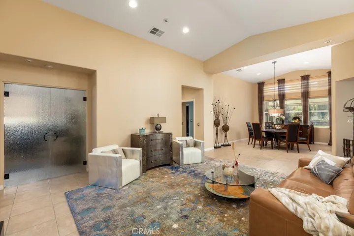 Living room/dining room -den/office behind double "rain glass doors" on left