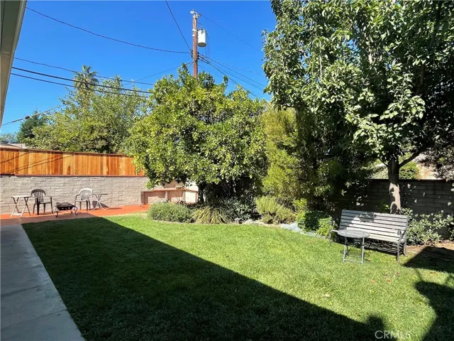 Private grassy yard with patio