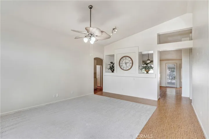 Entry to home.  Living room with carpet, ceramic tile and ceiling fan.