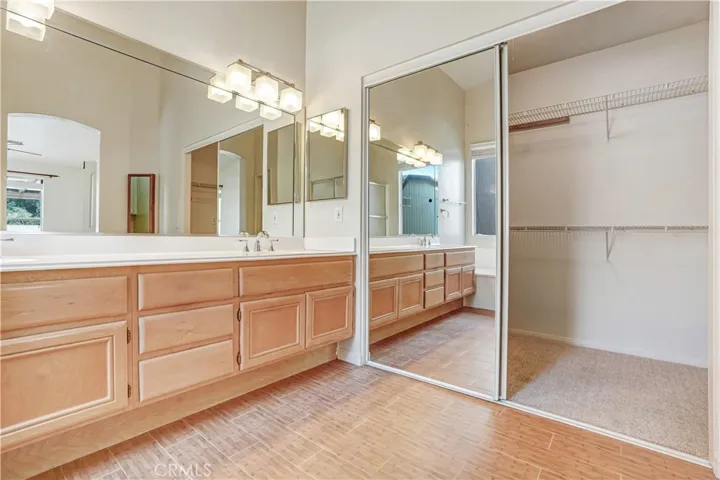 Master bath with large mirrored walk-in closet
