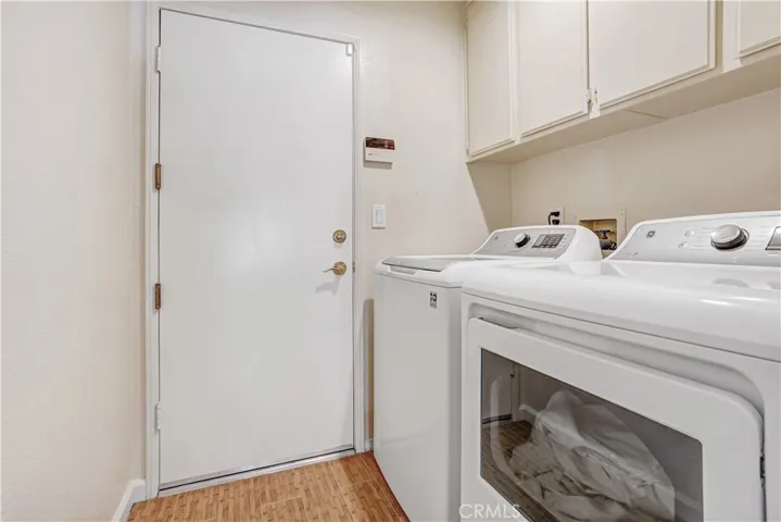 Inside laundry with plenty of cabinet space.