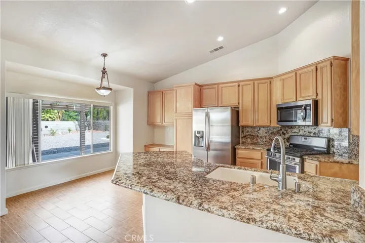 Kitchen with granite counters and stainless steel appliances.