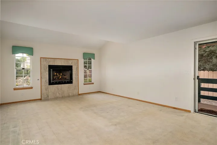 Main bedroom downstairs with fireplace and door to side of house