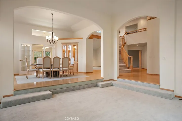 Living room looking towards entry, stairway and dining rom