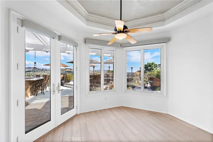 Kitchen Eating Area With Double Doors to Backyard Patio
