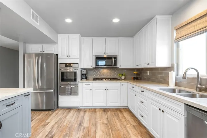 The hallway on the left has the garage door just behind the refrigerator so only 10 or 12 steps to bring your groceries in!! The Master is at the end of this hall and can also be entered from the hallway where secondary bath is.