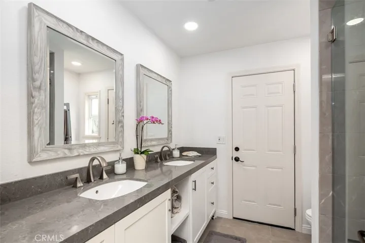 The secondary bath was completely remodeled in 2021. New vanity, step-in shower, countertops, mirrors and PEX through out the house. Lots of storage under vanity. Door to outside lets all the mess come to this room instead of thought the house! Great place to install an outdoor shower too!!