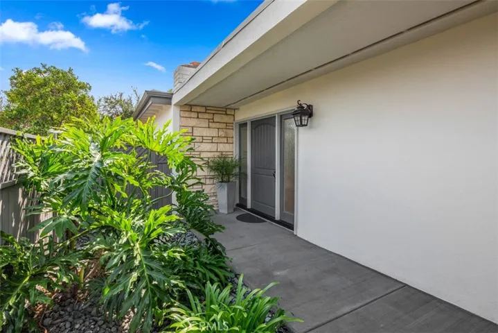 Private front door faces East and has side lights to create light entryway.