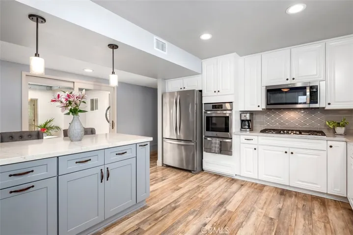 New cabinetry with self closing drawers and cabinets were installed along with new appliance in 2018-19. At the end of the island is a spice rack. GE profile 5 burner gas stove with built in microwave. Whirlpool oven, broiler and refrigerator are also newer.