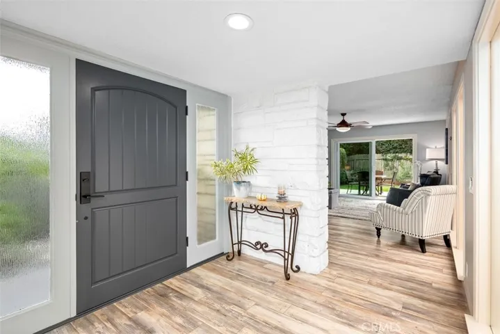 Enter the Foyer and feel the light all around you as there is an open air atrium right in front of you. To the left is the living room and to the right the dining room. The living space is built around the atrium which bring the soft breezes in.