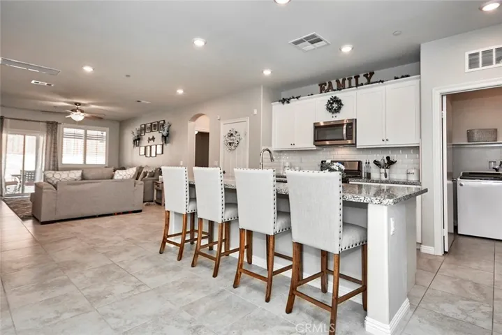 Open Floorplan & Massive Island.  Breakfast bar. pantry.  Laundry room off the kitchen.