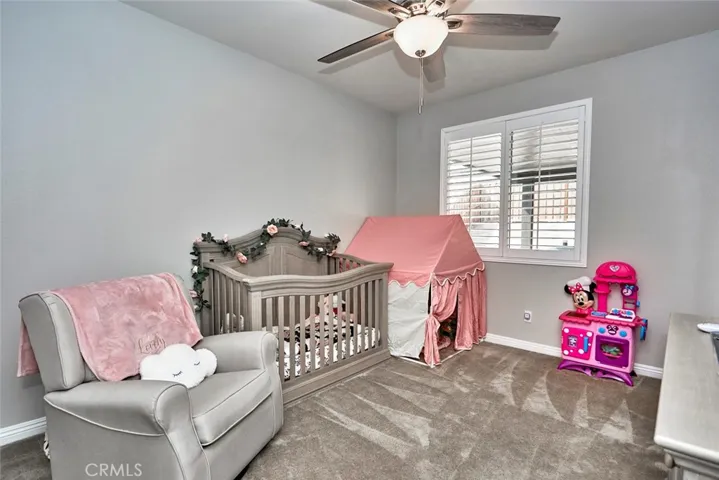 Bedroom #2 features plantation shutters, gorgeous carpet & ceiling fan.