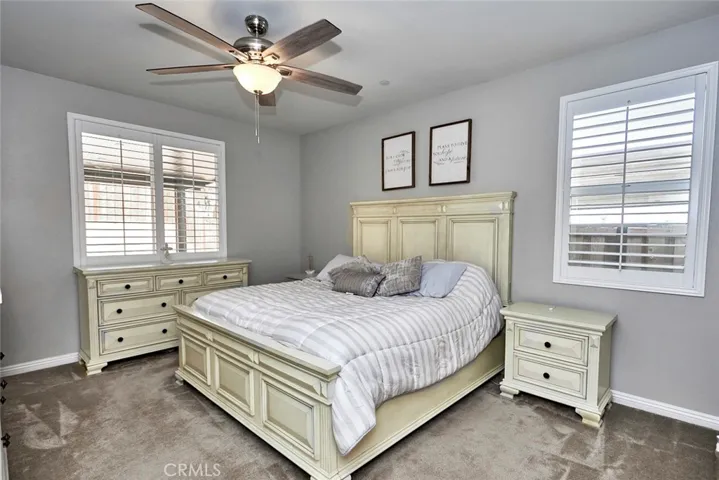 Two windows in the master have plantation shutters