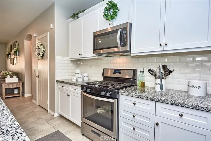 Modern Farmhouse Kitchen with stunning granite countertops, Shaker cabinets & Subway Tile