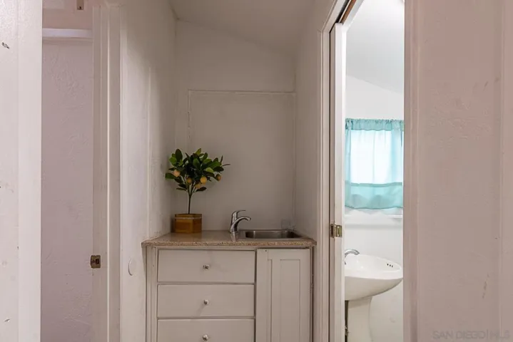 Wet bar in between 3rd bedroom and bath. All baths have showers only.