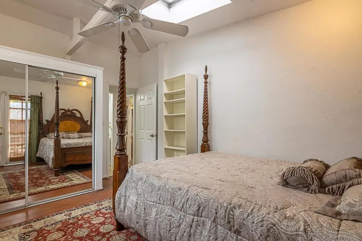 3rd bedroom with ceiling fan and mirror closet doors, separate entrance and a bath. Skylights throughout the home for natural lighting.