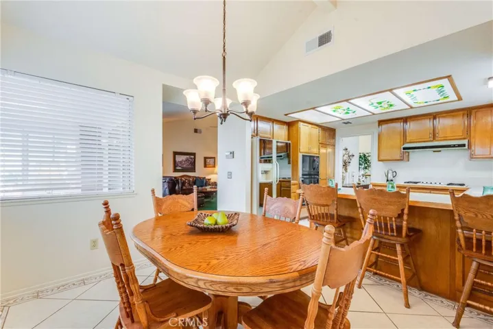 Here is a view of three rooms: kitchen, breakfast dining, and peekaboo of the family room.