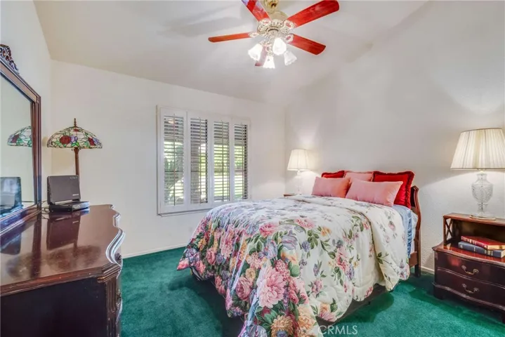 Front bedroom right off the hallway; the windows have shutters.