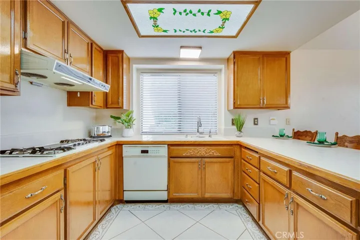 Spacious kitchen has lots of cabinets! Take note of the breakfast bar.