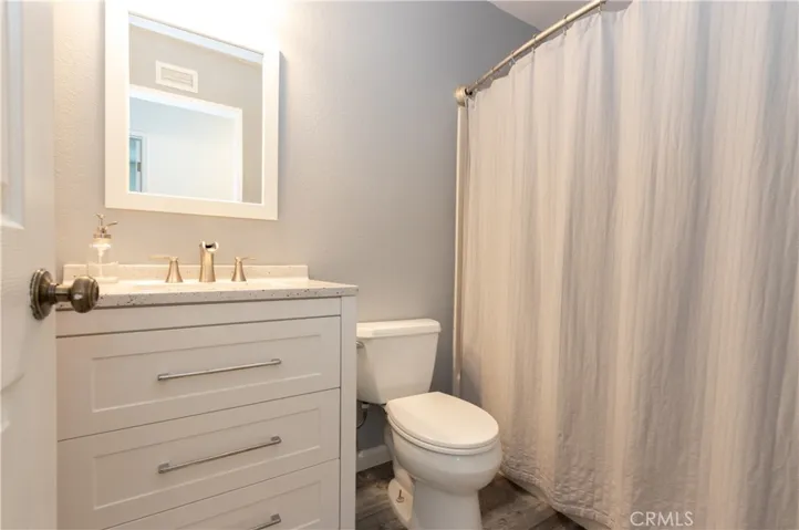 Second Bathroom with new cabinet, hardware, mirror and flooring