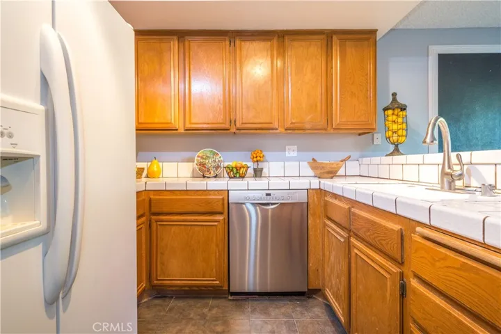 Kitchen with overhead cabinets and stainless dishwasher.