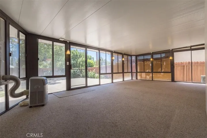 Spacious enclosed patio can be used as a rec room.