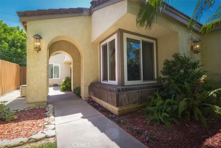 Attractive path leads to the courtyard entry through a stucco arch.